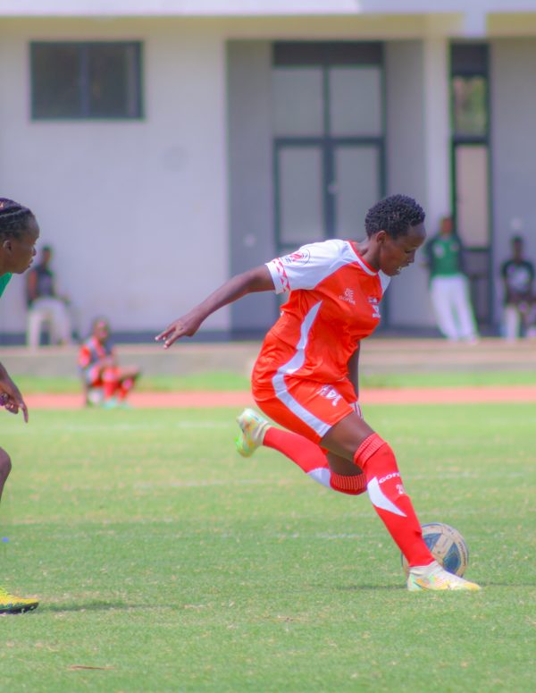 Kayole Starlets Esther Ngugi in Action against Kibera Soccer Women